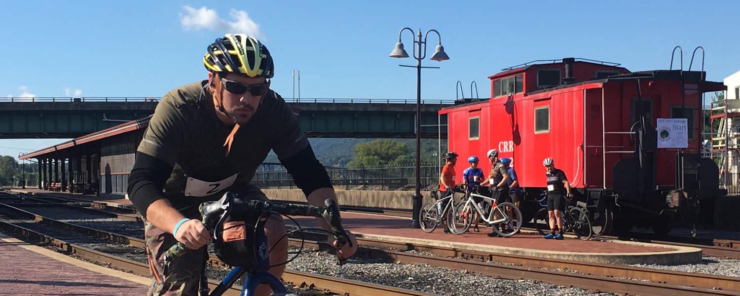 Cyclist passing Cumberland Caboose