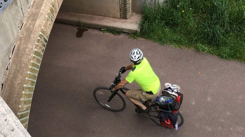 Cyclists biking under Eastern Continental Divide Tunnel