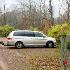 Parking lot with Sand Patch sign on fence